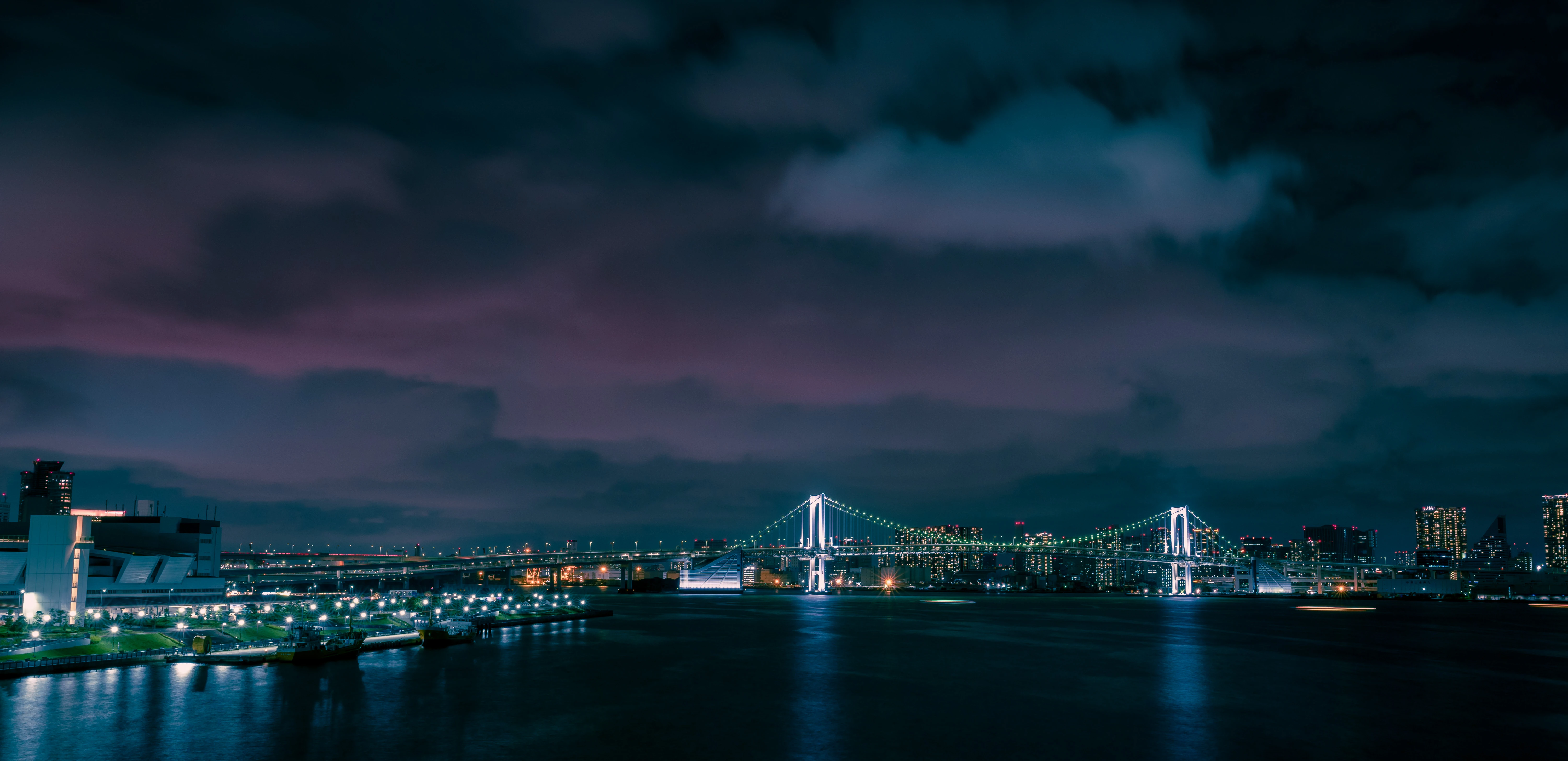Illuminated Bridge Under a Mystic Night Sky